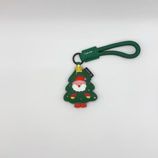 Christmas tree keychain with a green strap on a white background