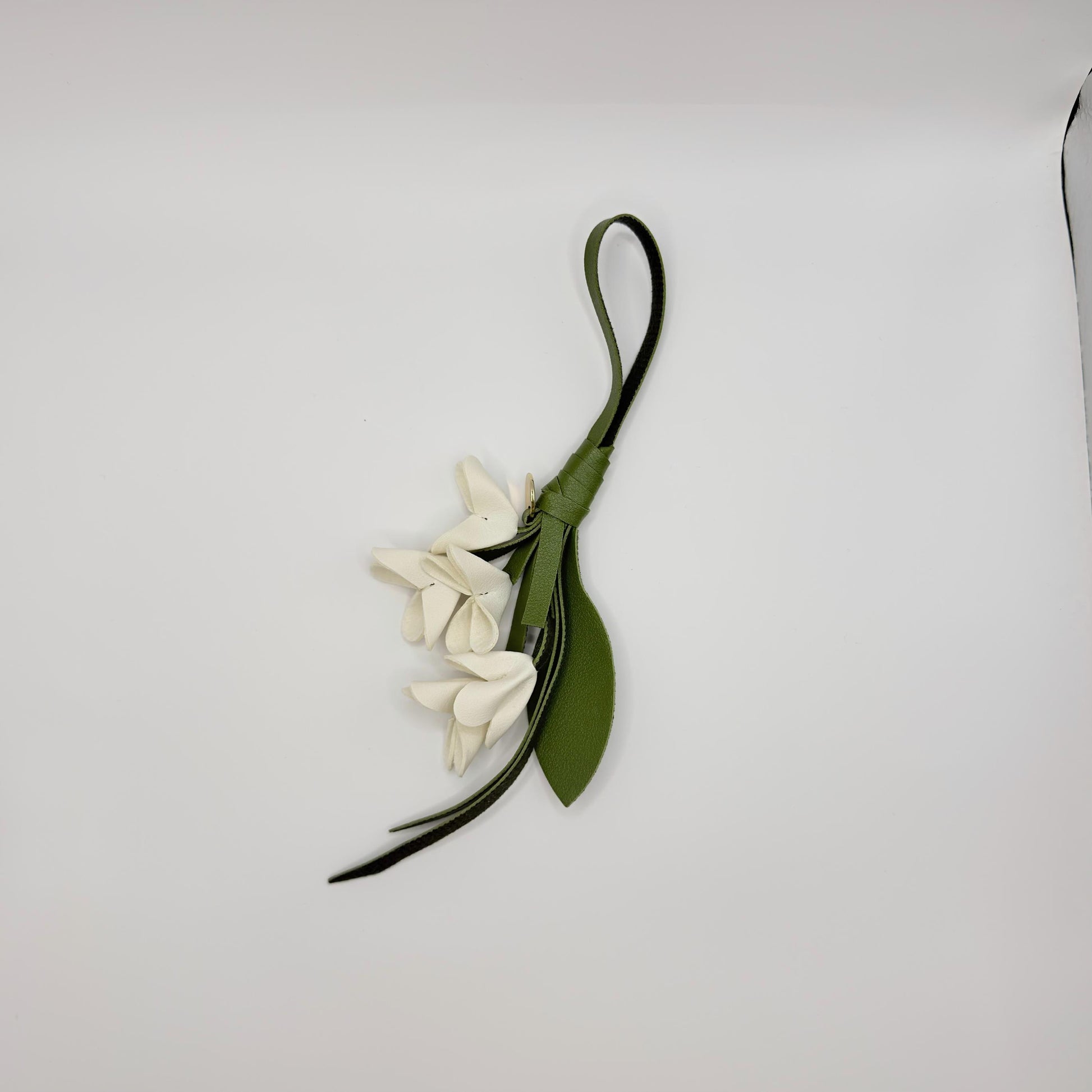 white vegan leather bluebell flower bag charm with green stems and leaf